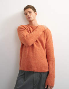Model wearing Relaxed fit crewneck knitted jumper in orange