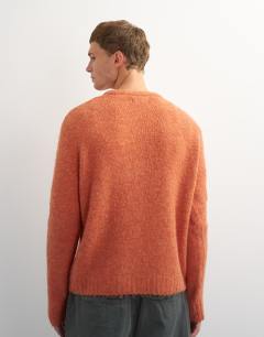 Model wearing Relaxed fit crewneck knitted jumper in orange