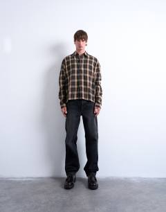 Model wearing Relaxed fit crop flannel shirt in brown check