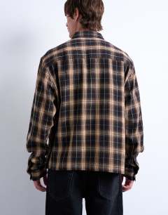 Model wearing Relaxed fit crop flannel shirt in brown check