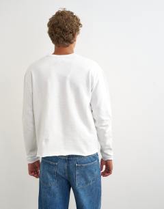 Model wearing Relaxed fit crop heavyweight slub raw edge henley in ecru