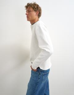 Model wearing Relaxed fit crop heavyweight slub raw edge henley in ecru