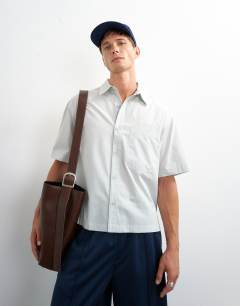 Model wearing Relaxed fit crop poplin shirt in sage