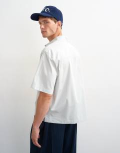 Model wearing Relaxed fit crop poplin shirt in sage