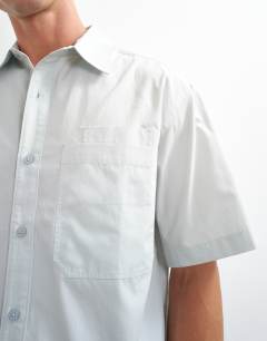 Model wearing Relaxed fit crop poplin shirt in sage