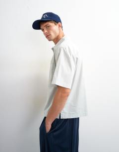 Model wearing Relaxed fit crop poplin shirt in sage