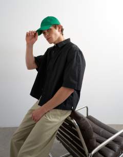 Model wearing Relaxed fit crop poplin short sleeve shirt in black