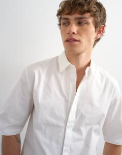 Model wearing Relaxed fit crop poplin short sleeve shirt in white