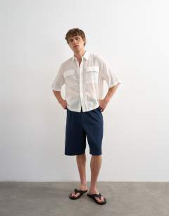 Model wearing Relaxed fit crop sheer ripstop short sleeve shirt in white