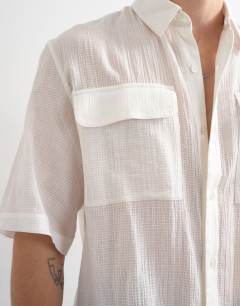 Model wearing Relaxed fit crop sheer ripstop short sleeve shirt in white