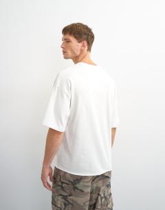 Model wearing Relaxed fit crop vintage rays print t-shirt with distressing in ivory