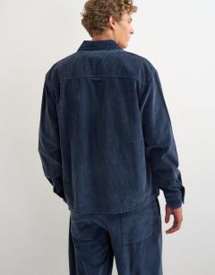 Model wearing Relaxed fit crop washed cord overshirt in washed blue