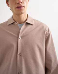 Model wearing Relaxed fit cropped polo in taupe