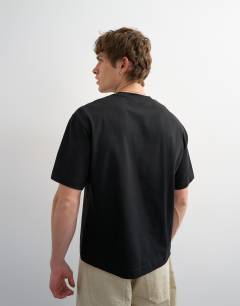 Model wearing Relaxed fit cropped t-shirt in black