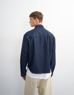 Model wearing Relaxed fit denim overshirt in mid blue