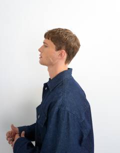 Model wearing Relaxed fit denim overshirt in mid blue