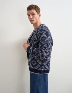 Model wearing Relaxed fit diamond knitted cardigan in navy
