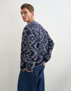 Model wearing Relaxed fit diamond knitted cardigan in navy