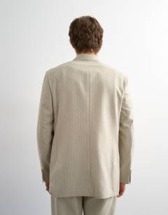 Model wearing Relaxed fit double breasted stripe blazer in stone