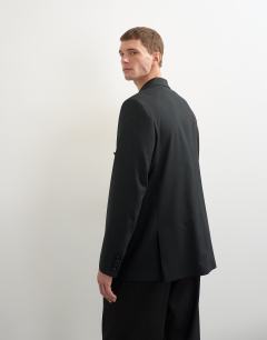 Model wearing Relaxed fit double breasted tuxedo blazer in black