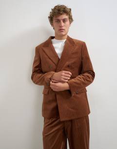 Model wearing Relaxed fit double breasted velvet stripe blazer in tan