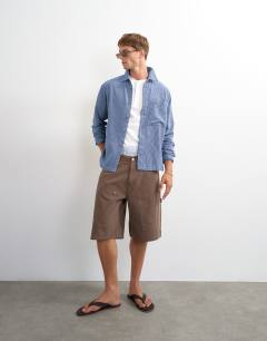 Model wearing Relaxed fit flannel check shirt in blue