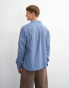 Model wearing Relaxed fit flannel check shirt in blue