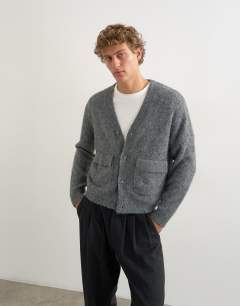 Model wearing Relaxed fit fluffy double pocket knitted cardigan in grey