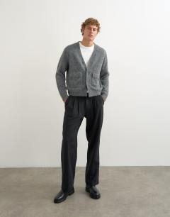 Model wearing Relaxed fit fluffy double pocket knitted cardigan in grey