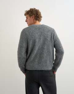 Model wearing Relaxed fit fluffy double pocket knitted cardigan in grey
