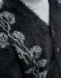 Model wearing Relaxed fit fluffy knit cardigan with floral design in black