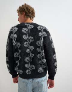 Model wearing Relaxed fit fluffy knit cardigan with floral design in black
