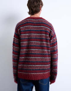 Model wearing Relaxed fit fluffy knitted stripe jumper in burgundy