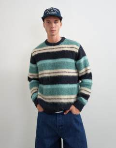 Model wearing Relaxed fit fluffy striped knitted jumper in teal