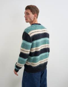 Model wearing Relaxed fit fluffy striped knitted jumper in teal