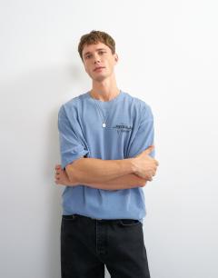 Model wearing Relaxed fit front and back social club print t-shirt in blue