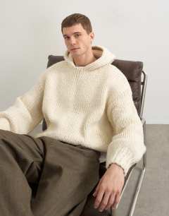 Model wearing Relaxed fit hand knitted heavyweight hoodie in ecru