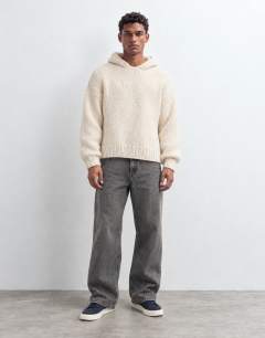 Model wearing Relaxed fit hand knitted heavyweight hoodie in ecru