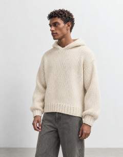 Model wearing Relaxed fit hand knitted heavyweight hoodie in ecru