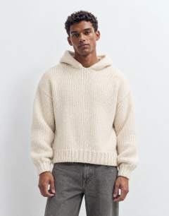 Model wearing Relaxed fit hand knitted heavyweight hoodie in ecru