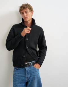 Model wearing Relaxed fit heavyweight funnel neck jumper in black