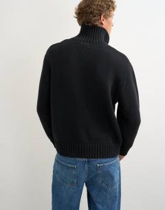 Model wearing Relaxed fit heavyweight funnel neck jumper in black