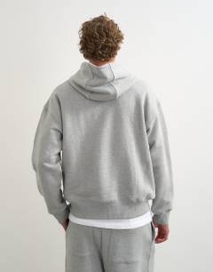 Model wearing Relaxed fit heavyweight hoodie in grey marl