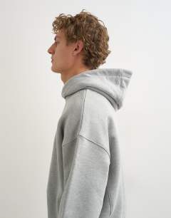 Model wearing Relaxed fit heavyweight hoodie in grey marl