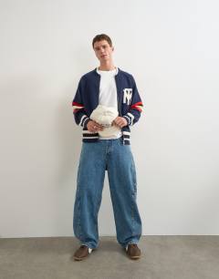 Model wearing Relaxed fit heavyweight knit varsity cardigan in navy