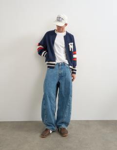 Model wearing Relaxed fit heavyweight knit varsity cardigan in navy
