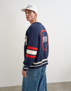 Model wearing Relaxed fit heavyweight knit varsity cardigan in navy