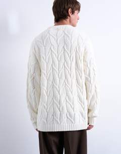 Model wearing Relaxed fit heavyweight knitted jumper with cable in cream