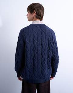 Model wearing Relaxed fit heavyweight knitted jumper with cable in navy
