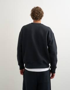 Model wearing Relaxed fit heavyweight sweatshirt in black
